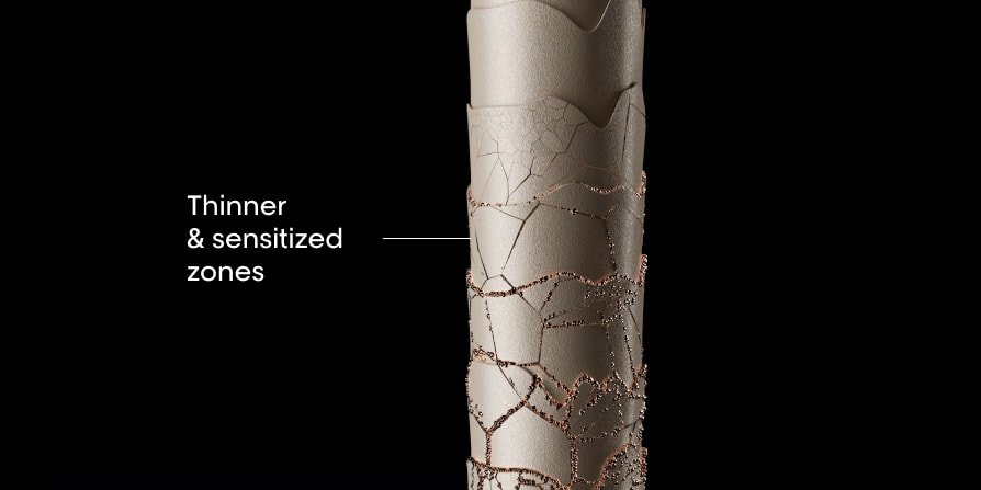 Close-up of damaged hair showing thinner, weakened strands and sensitized zones along the lengths, highlighting breakage-prone areas.
