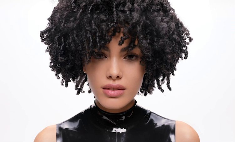 Focus on various women with different types of curly hair, presenting the L’Oréal Curly Hair Care routine for every curl type.