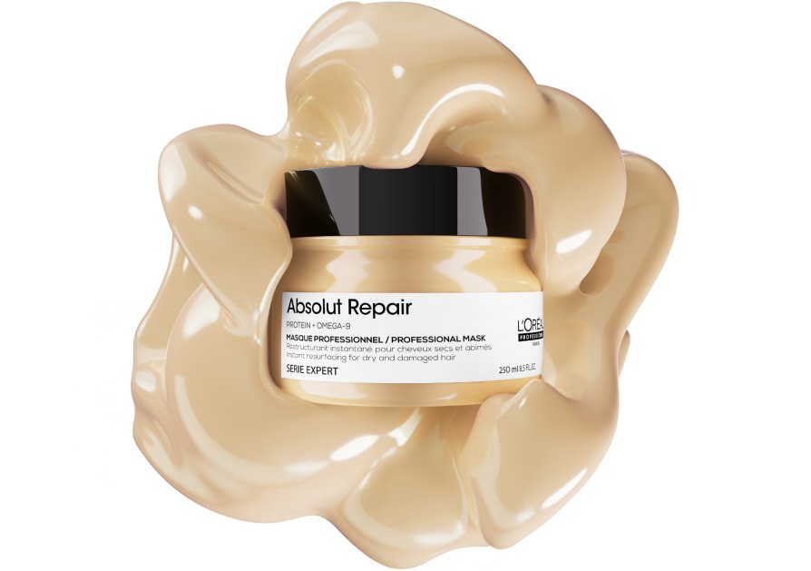 Packshot of L’Oréal Professionnel Absolut Repair hair mask on a textured background, highlighting its rich, buttery texture for damaged hair.